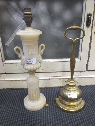Lot 454 - A brass door stop with loop handle and an...