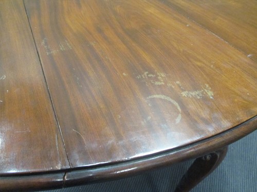 Lot 444 - A George III mahogany oval drop leaf dining table