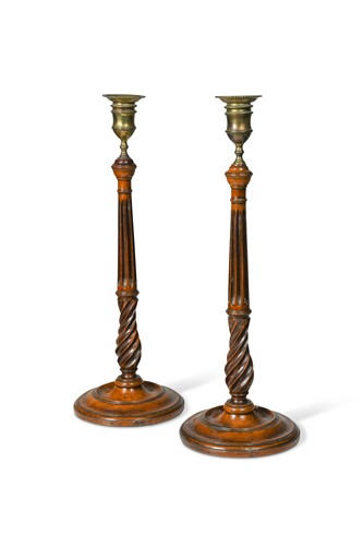 Lot 411 - A pair of George III brass and mahogany candlesticks