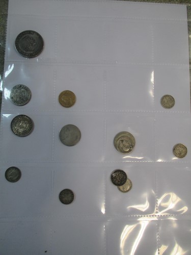 Lot 376 - A folder of coins, including 1887 half...