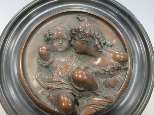 Lot 117 - A pair of pressed metal roundels of children,...
