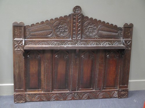 Lot 856 - A carved oak panelled head board with...