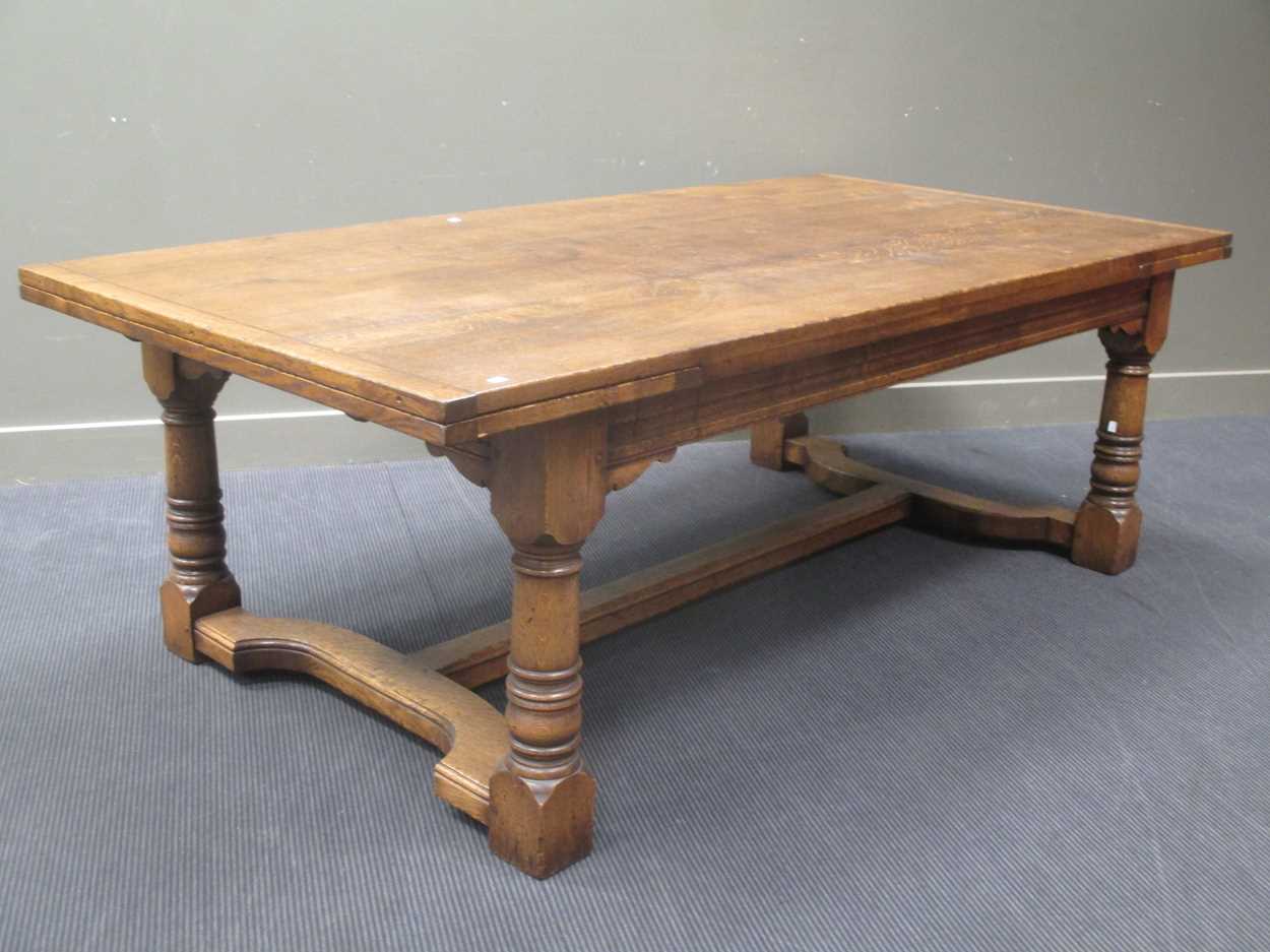 Lot 700 - A 17th century style oak dining table, with...