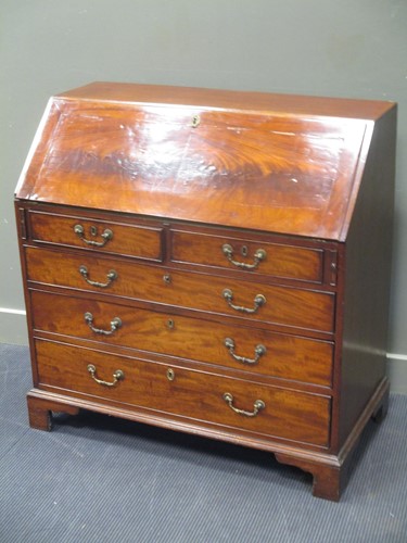 Lot 692 - A George III mahogany bureau, circa 1770, with...