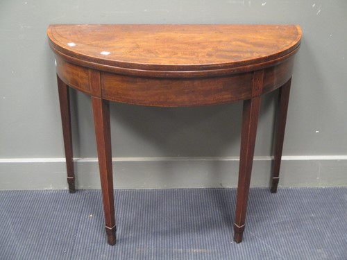 Lot 693 - A George III mahogany demi-lune card table,...