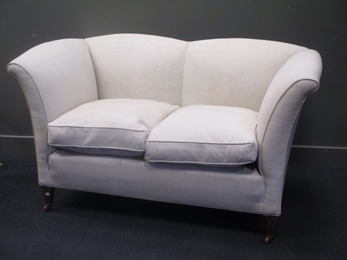 Lot 862 - A two seat ivory upholstered fan-back sofa, on...