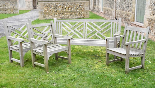 Lot 480 - A weathered garden bench and a pair of arm chairs, late 20th century