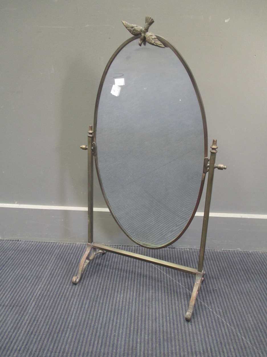 Lot 691 - A brass framed oval dressing table mirror,...