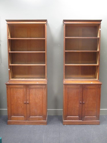 Lot 849 - Two similar Edwardian oak open bookcases above...