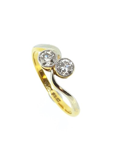 Lot 84 - A two stone diamond crossover style ring