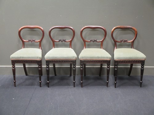 Lot 812 - A set of four rosewood balloon back dining...