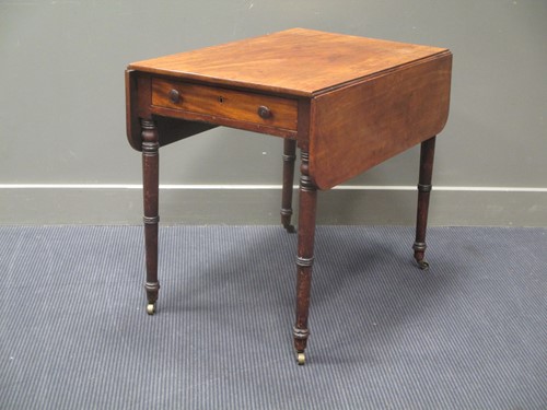 Lot 750 - A mahogany Pembroke table on turned legs with...
