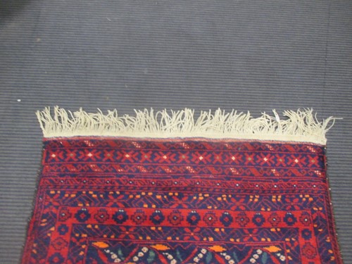 Lot 900 - A Beluchi style runner, modern 310 x 79cm
