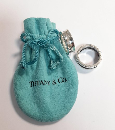 Lot 395 - Bvlgari 'Save the Children' silver ring along...