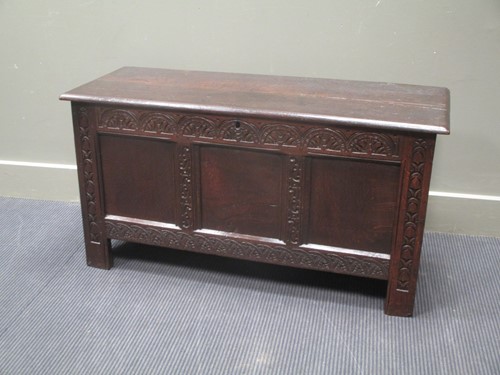 Lot 827 - An 18th century three panel coffer with carved...