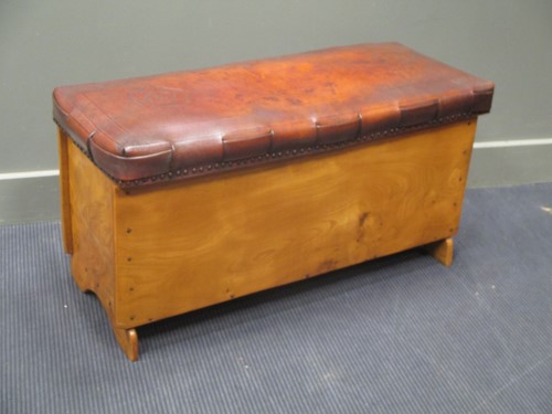 Lot 584 - An embossed leather seat elm chest with Tudor...