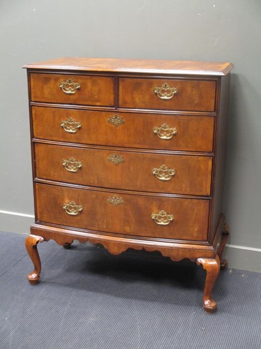 Lot 479 - A George III walnut bow front chest of two...