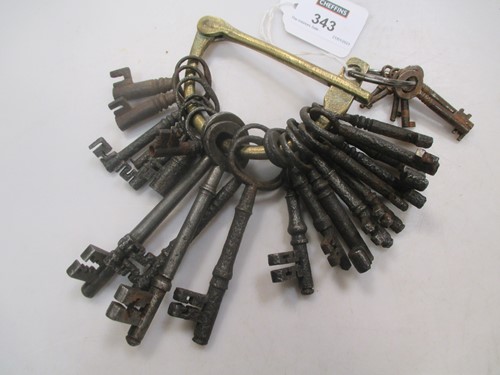 Lot 343 - A collection of vintage keys on brass hasp