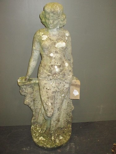 Lot 892 - A garden figure of a maiden wearing a headband,...