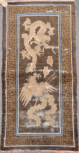 Lot 179 - A woollen rug, possibly Chinese with a dragon...