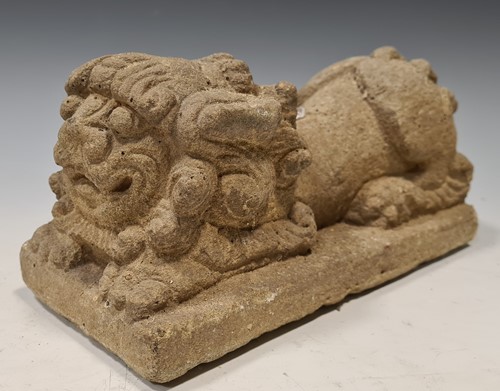 Lot 203 - A Chinese carved grey- stone crouched Fo dog,...