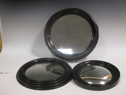 Lot 516 - Two small ebonised frame convex wall mirrors;...