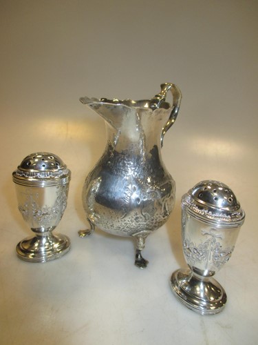 Lot 465 - A pair of silver pepperettes and a cream jug...