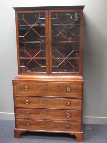 Lot 669 - A George III mahogany secretaire bookcase with...