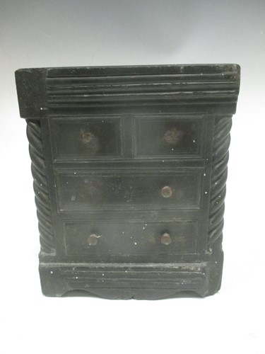 Lot 27 - A carved slate miniature chest of drawers...