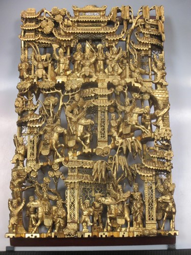 Lot 370 - A Chinese gold painted carved wooden panel...