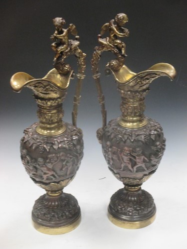 Lot 36 - A pair of gilt metal and metal ewers...