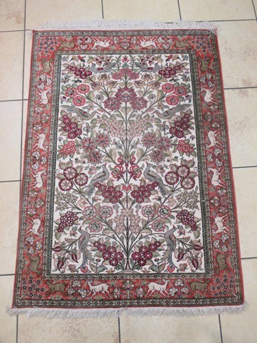 Lot 644 - An Tabriz silk rug, with a cream ground,...