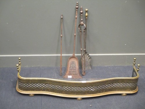 Lot 793 - A brass fender together with a set of fire irons