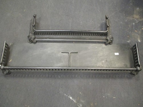 Lot 879 - A black pierced steel fender 132cm wide...