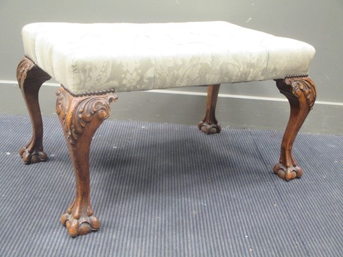 Lot 565 - A large George II style stool, the buttoned...