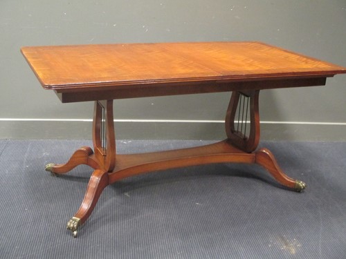 Lot 496 - A Duncan Phyfe style dining table with one...