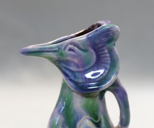 Lot 23 - Attributed to Brannam Pottery, a small grotesque Jug