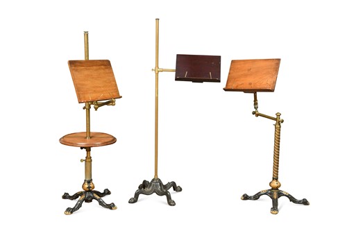 Lot 389 - A group of three Edwardian mahogany and brass adjustable reading stands