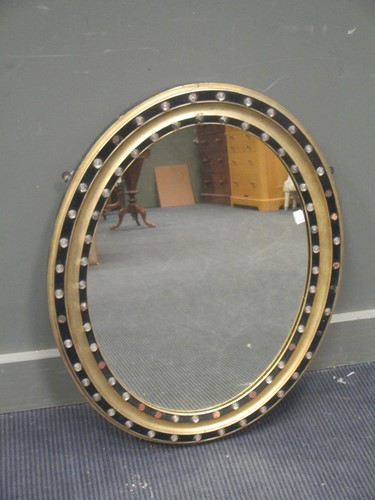 Lot 590 - An oval parcel gilt and beaded frame mirror,...