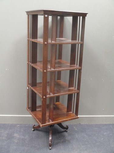 Lot 570 - A large four tier stained wood revolving...