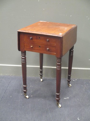 Lot 557 - A George IV mahogany drop flap table with two...