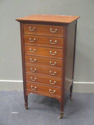 Lot 546 - A mahogany music cabinet with seven drawers,...