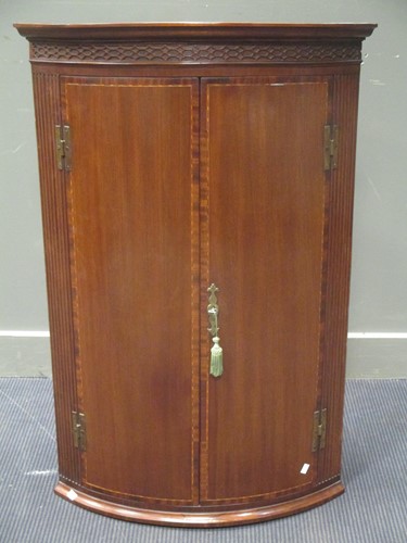 Lot 526 - A George III mahogany bow front corner...