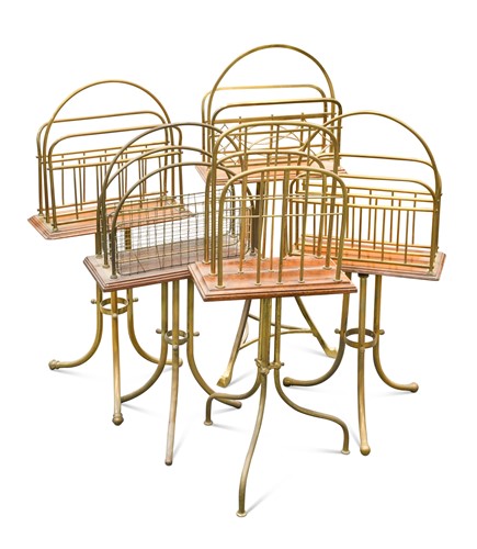 Lot 388 - A group of five brass and oak mounted magazine racks, early 20th century