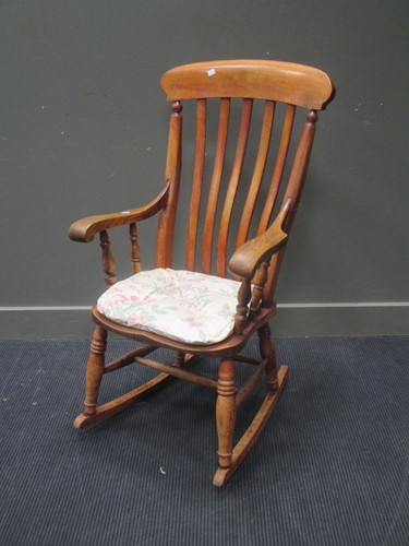 Lot 457 - A beech and elm lath back rocking chair