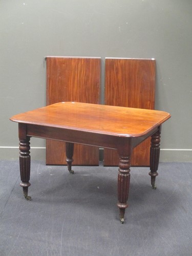 Lot 554 - A Victorian mahogany dining table with two leaves