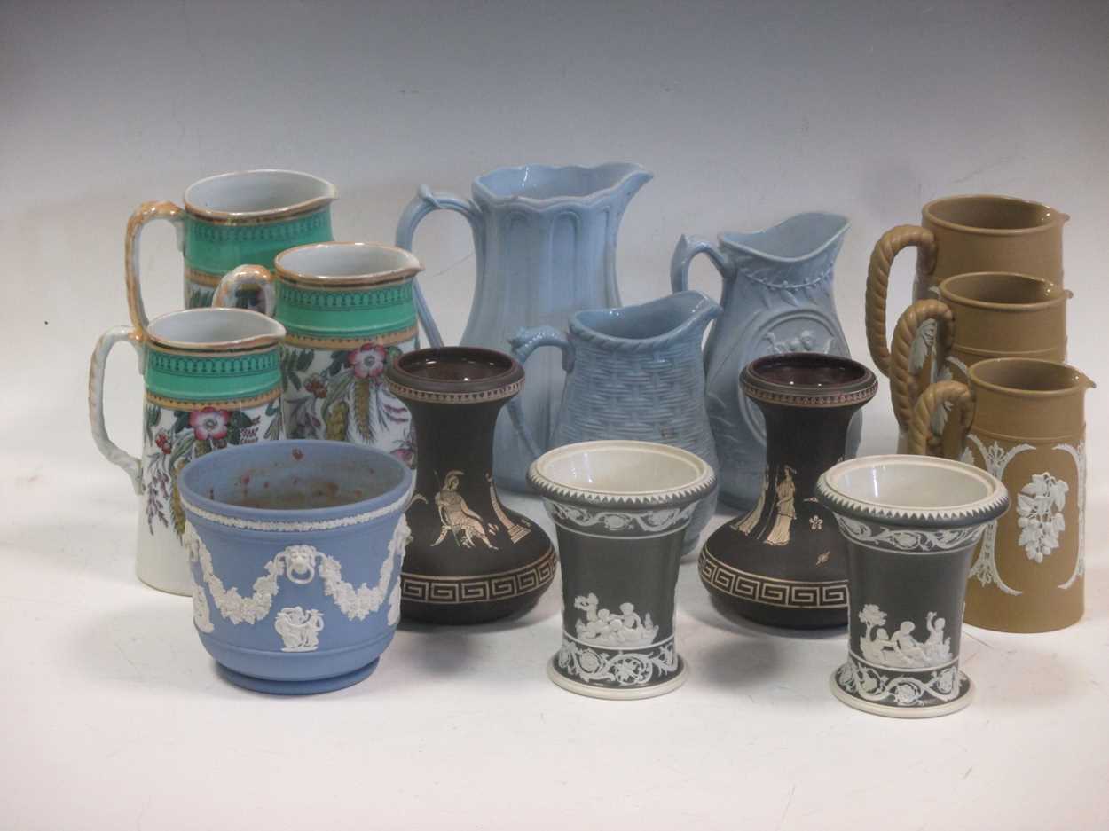 Lot 83 - A collection of relief moulded jugs, a game