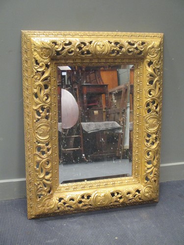 Lot 482 - A pierced gilt wood frame wall mirror with...