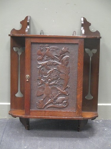 Lot 633 - An Arts and Crafts oak and walnut hanging...