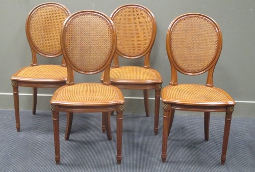 Lot 494 - A set of four Louis XVI style salon chairs...